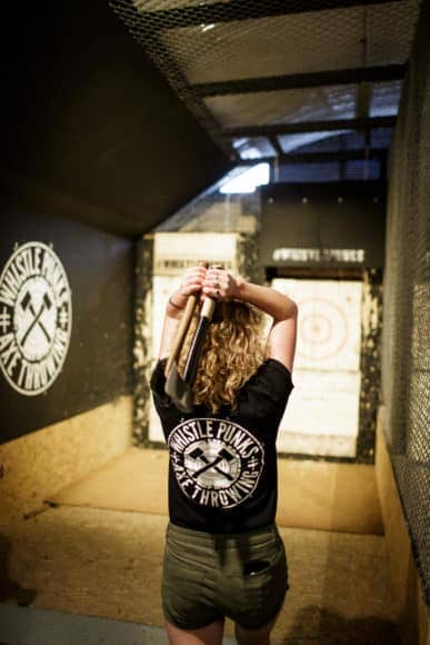 woman throwing 2 axes