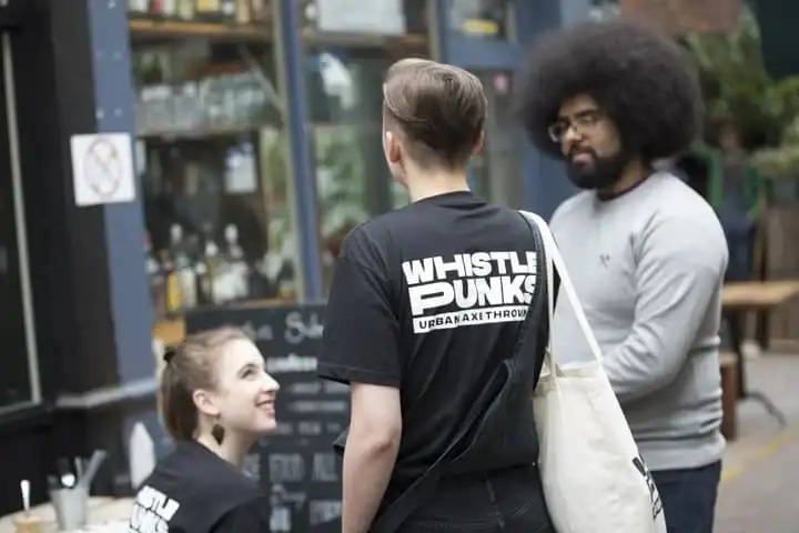 staff chatting outside of Whistle Punks