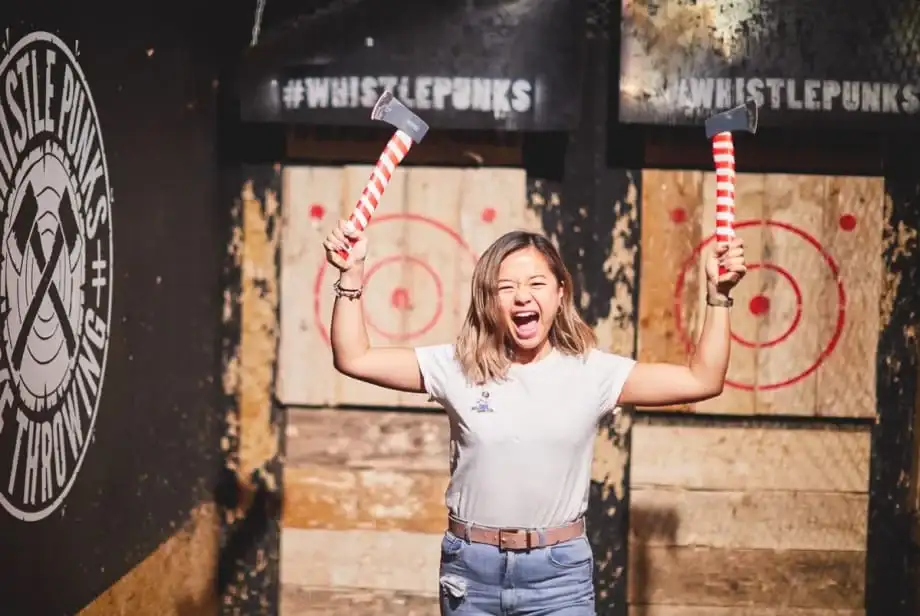 woman holding up 2 festive axes